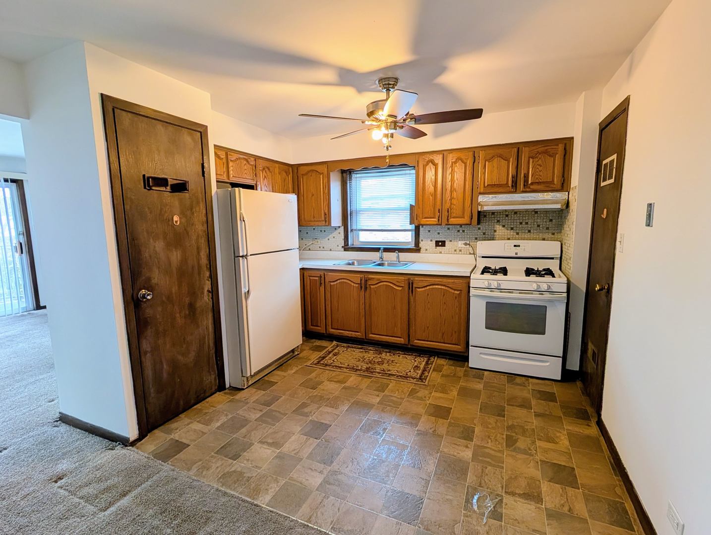 8143 Marion Drive, Unit 3E Justice, IL 60458 - Photo 5 of 9 a kitchen with stainless steel appliances granite countertop a refrigerator a sink a stove and island