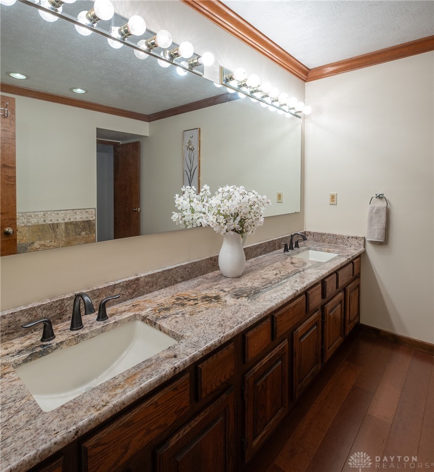 273 North Alpha Bellbrook Road Dayton, OH 45434 - Photo 27 of 43 This spacious bathroom features a double vanity and rich hardwood flooring.