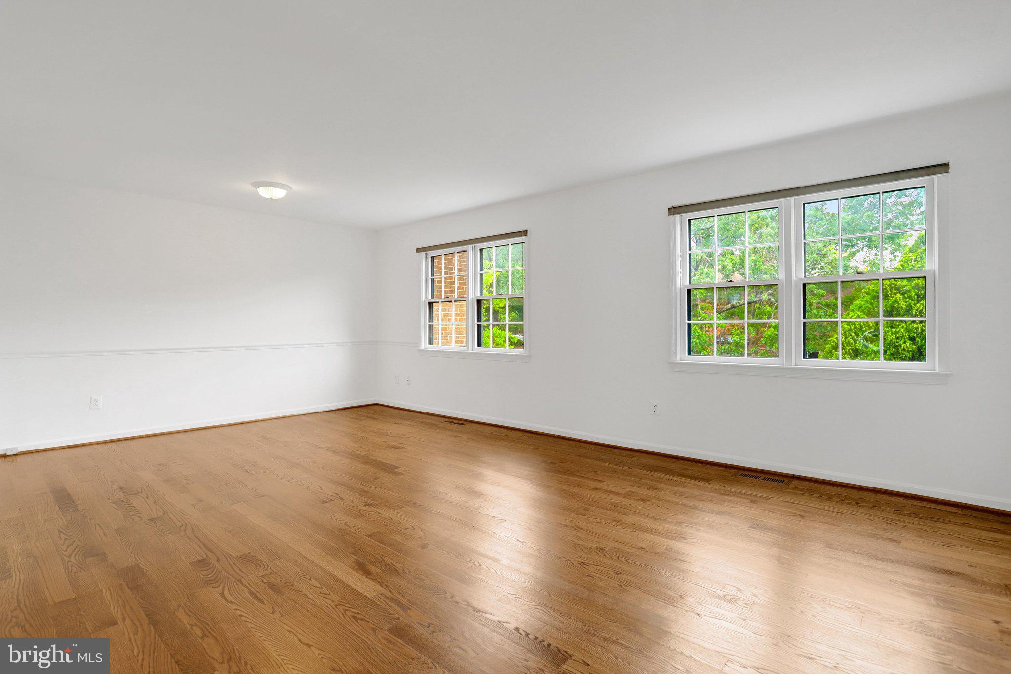2225 North Tuckahoe Street Arlington, VA 22205 - Photo 4 of 37 a view of an empty room with wooden floor and windows