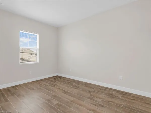 a view of an empty room and wooden floor
