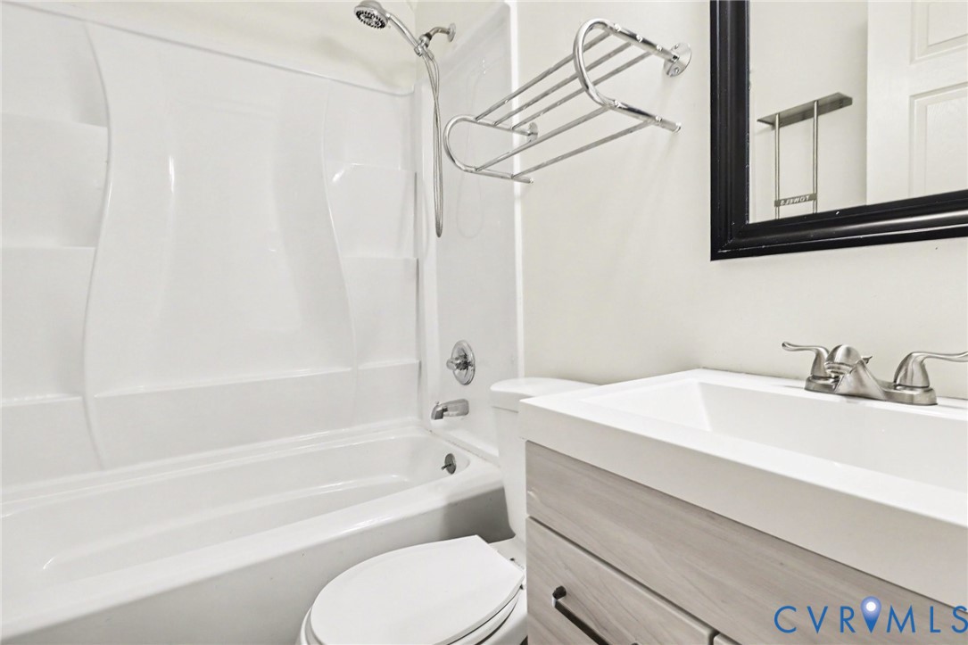 6921 Hines Road Disputanta, VA 23842 - Photo 21 of 35 White tub and shower combination, nice vanity, and