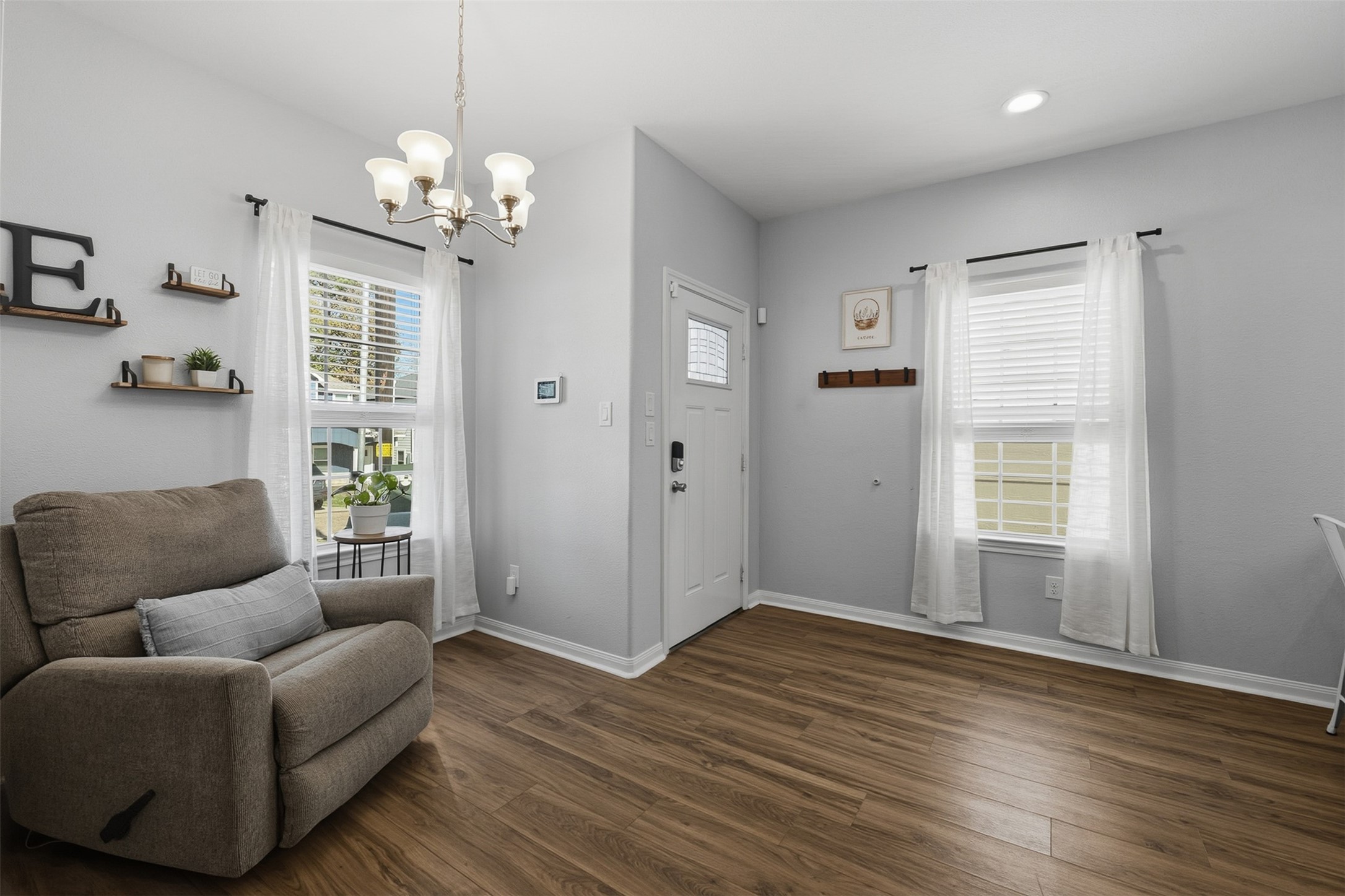16879 Balmoral Street Montgomery, TX 77316 - Photo 11 of 25 a living room with furniture and a chandelier