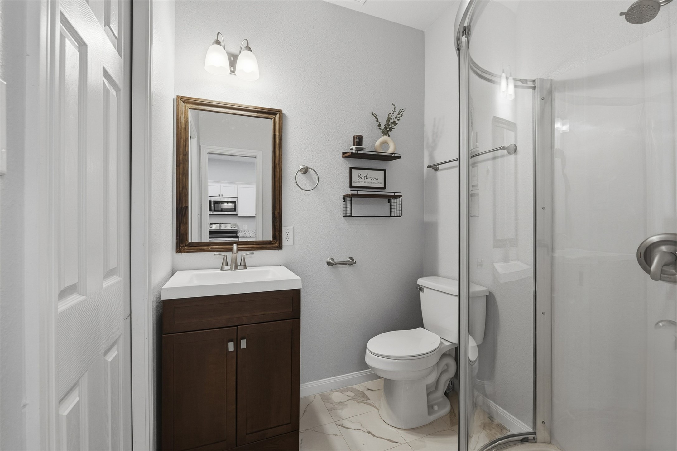 16879 Balmoral Street Montgomery, TX 77316 - Photo 20 of 25 a bathroom with a toilet a sink and mirror