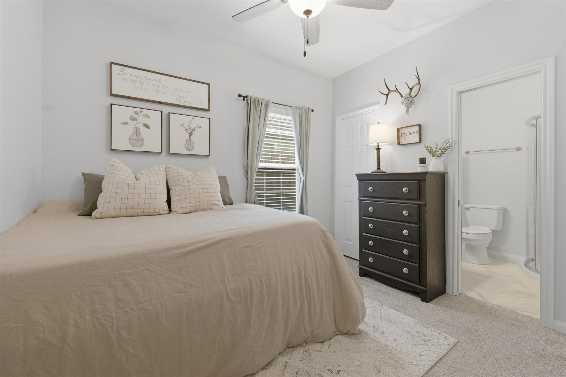 16879 Balmoral Street Montgomery, TX 77316 - Photo 2 of 25 a bedroom with a bed and a painting on the wall