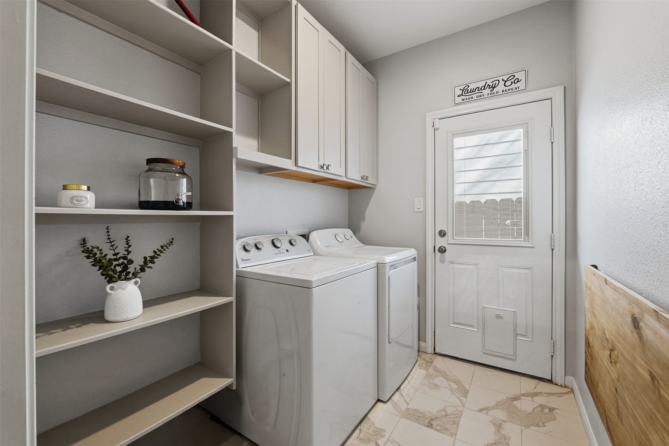 16879 Balmoral Street Montgomery, TX 77316 - Photo 22 of 25 a utility room with cabinets washer and dryer