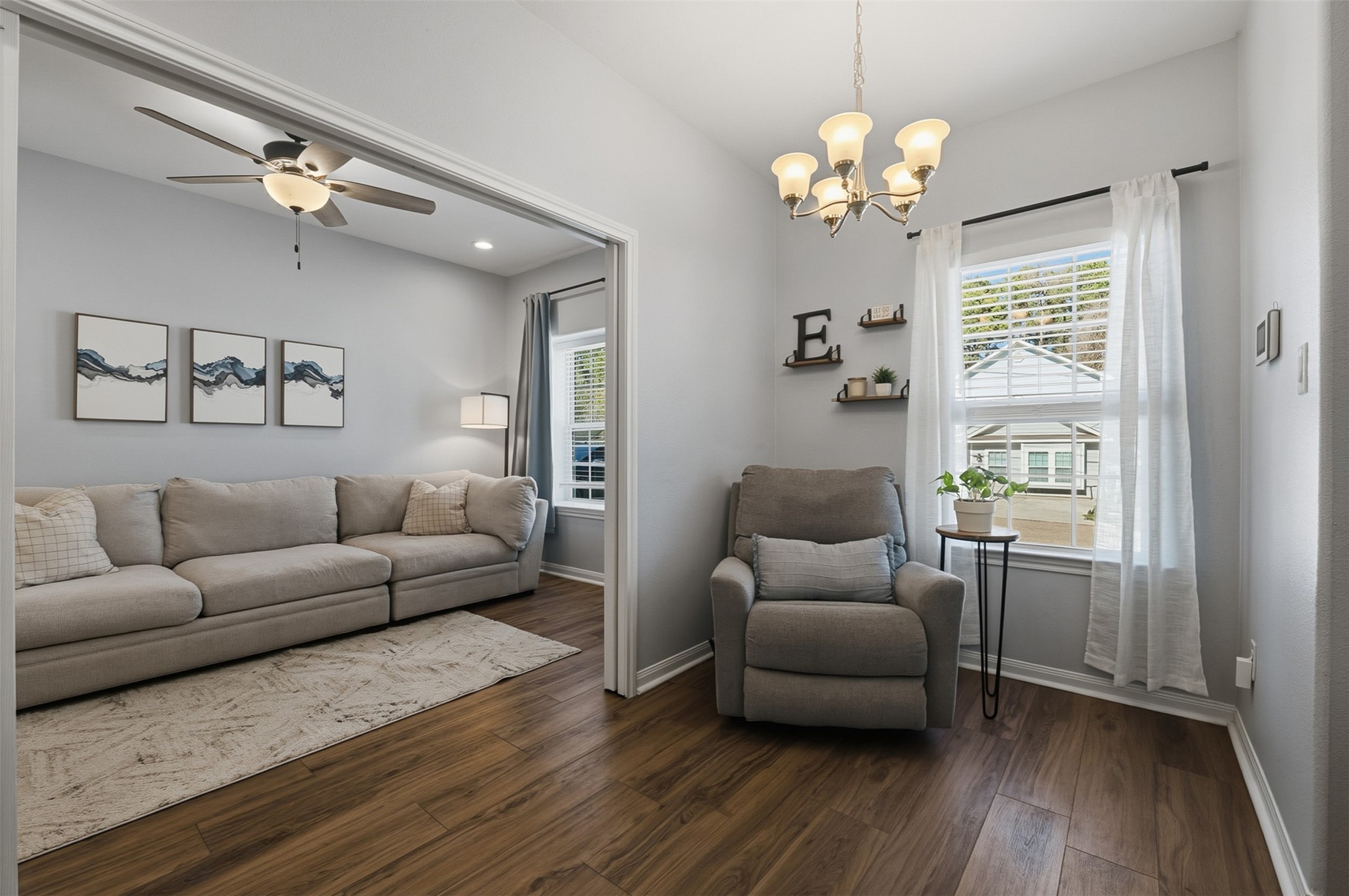 16879 Balmoral Street Montgomery, TX 77316 - Photo 3 of 25 a living room with furniture and a chandelier