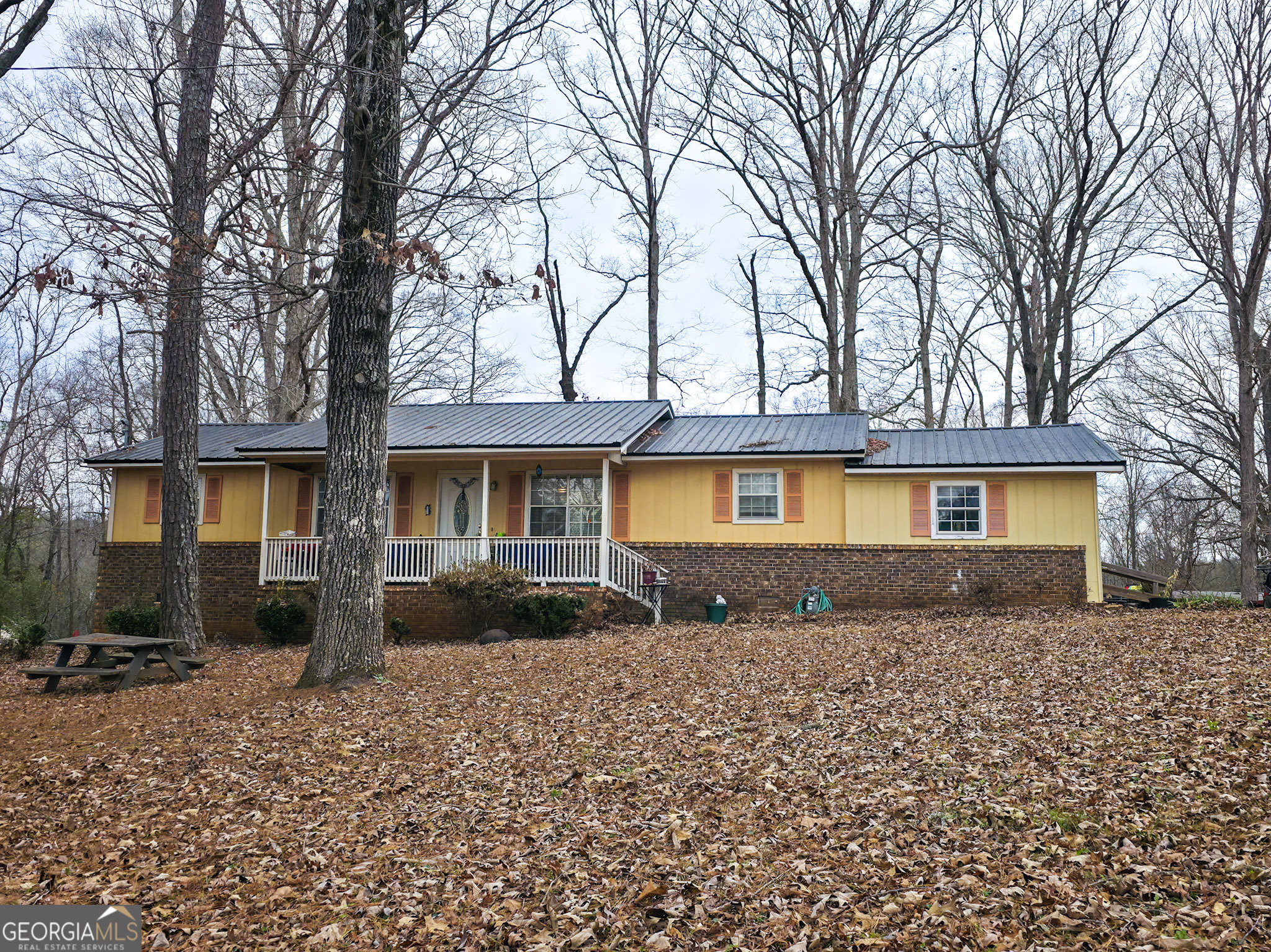 107 Maynard Street Thomaston, GA 30286 - Photo 1 of 1 a front view of a house with a yard and a garage