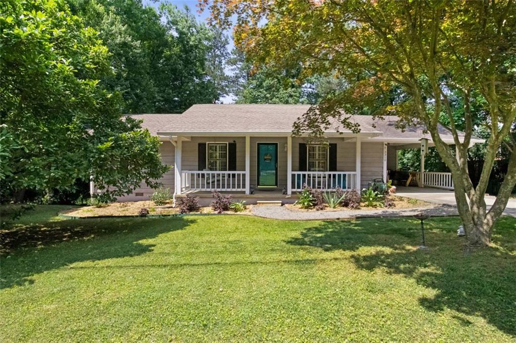 a front view of a house with a garden