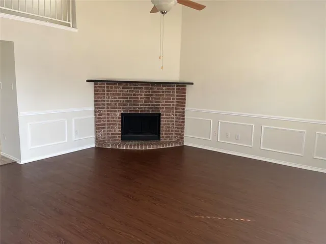 a view of staircase with white walls and fan