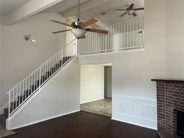 a view of an empty room with a chandelier