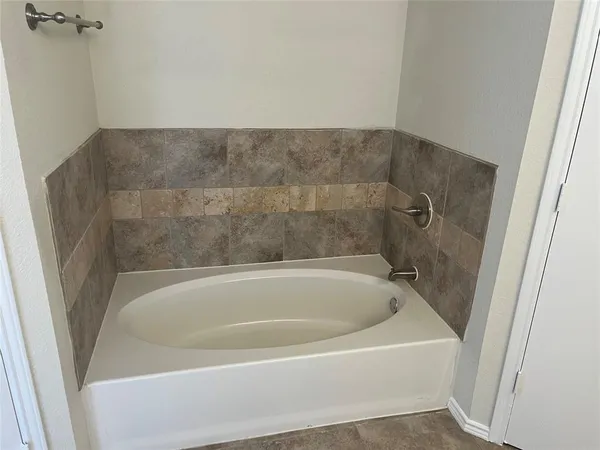 a bathroom with a tub a sink and a shower
