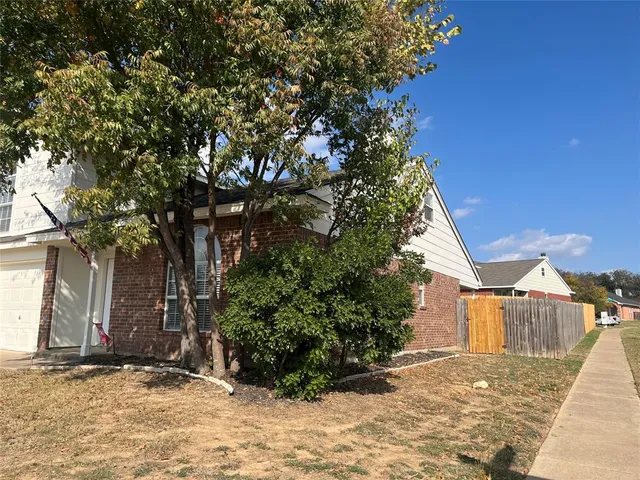 a view of a house with a tree in the background