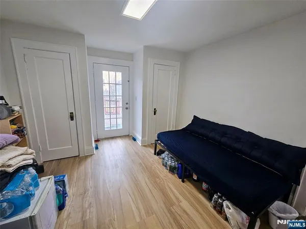 a living room with wooden floors and a chair