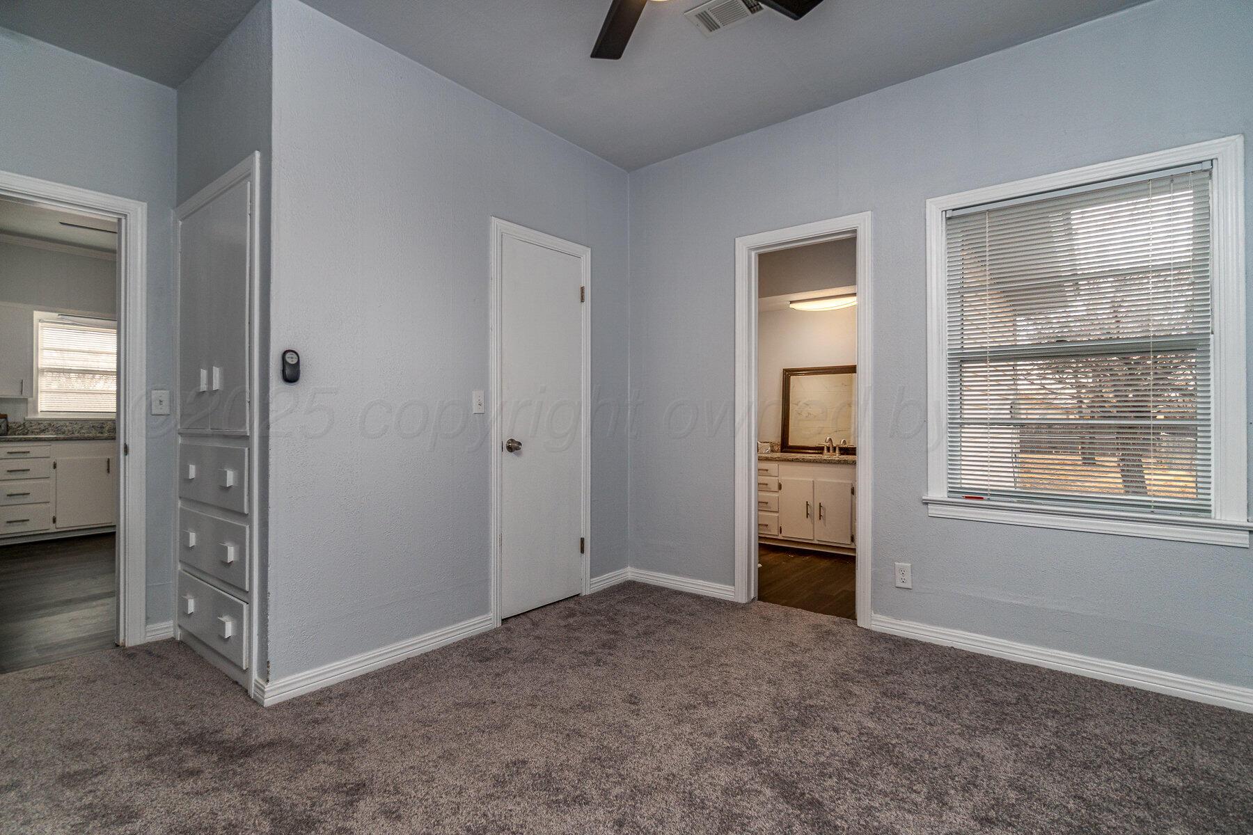 700 21st Street Canyon, TX 79015 - Photo 20 of 30 an empty room with windows and closet