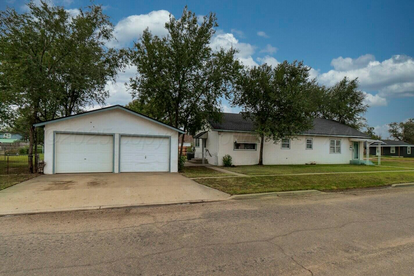 700 21st Street Canyon, TX 79015 - Photo 3 of 30 a front view of a house with a yard and garage