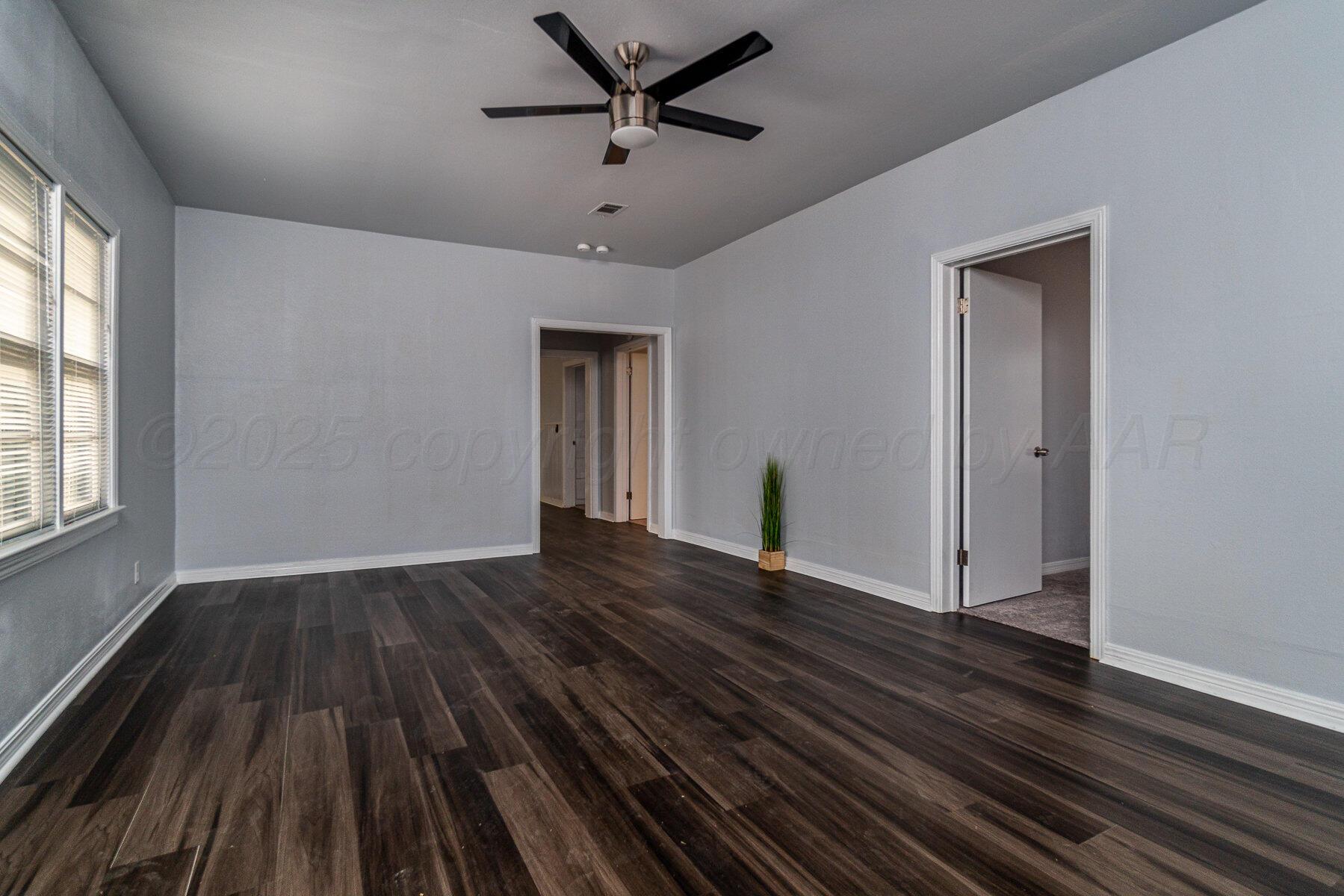 700 21st Street Canyon, TX 79015 - Photo 9 of 30 wooden floor in an empty room with a window