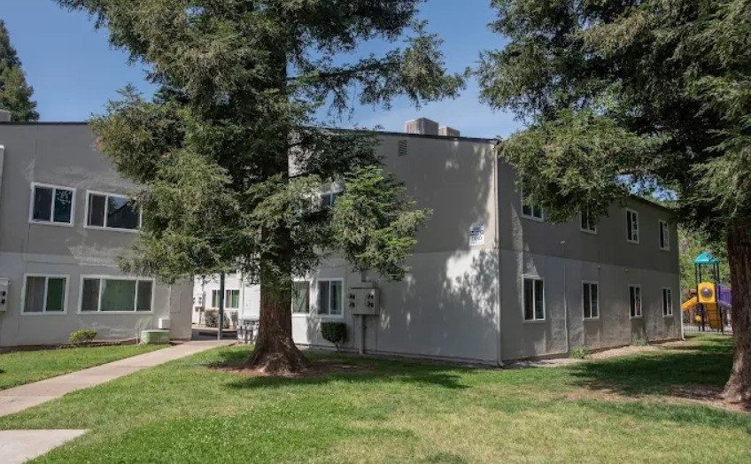 1895 Benton Drive Redding, CA 96003 - Photo 2 of 9 a front view of a house with a garden and tree