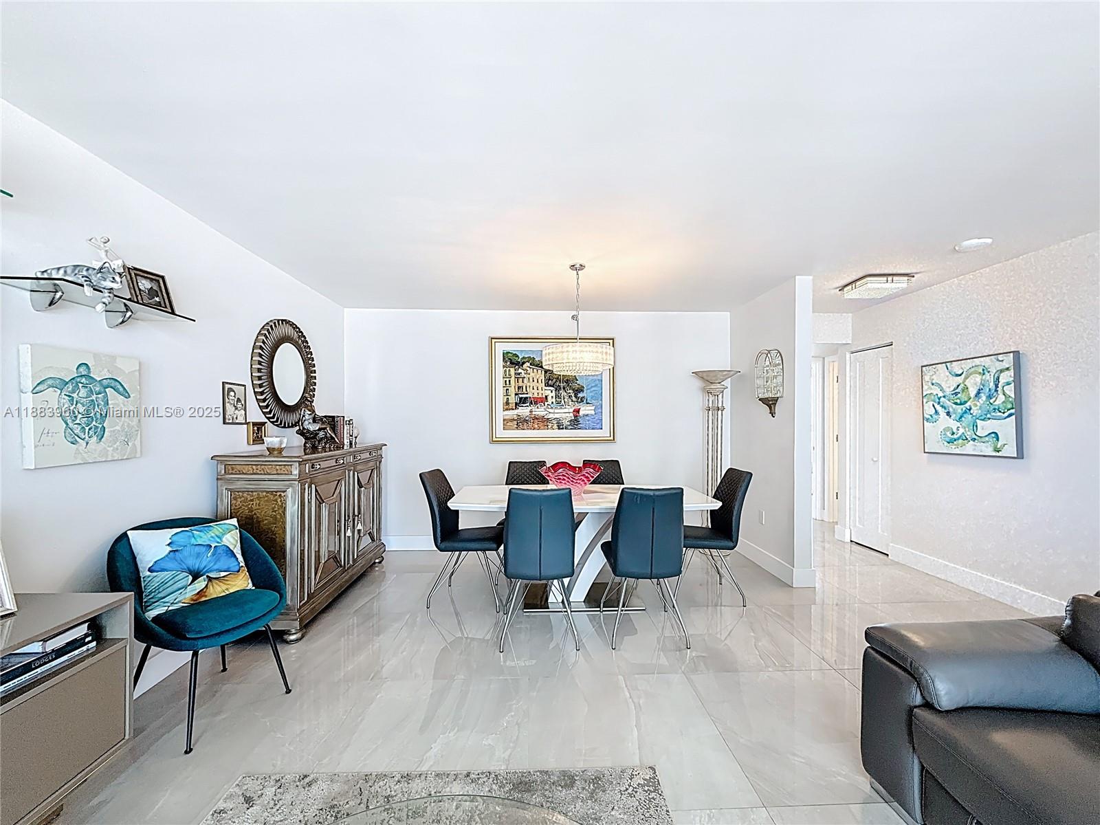 6061 Collins Avenue, Unit 20C Miami Beach, FL 33140 - Photo 11 of 29 a living room with furniture and wooden floor