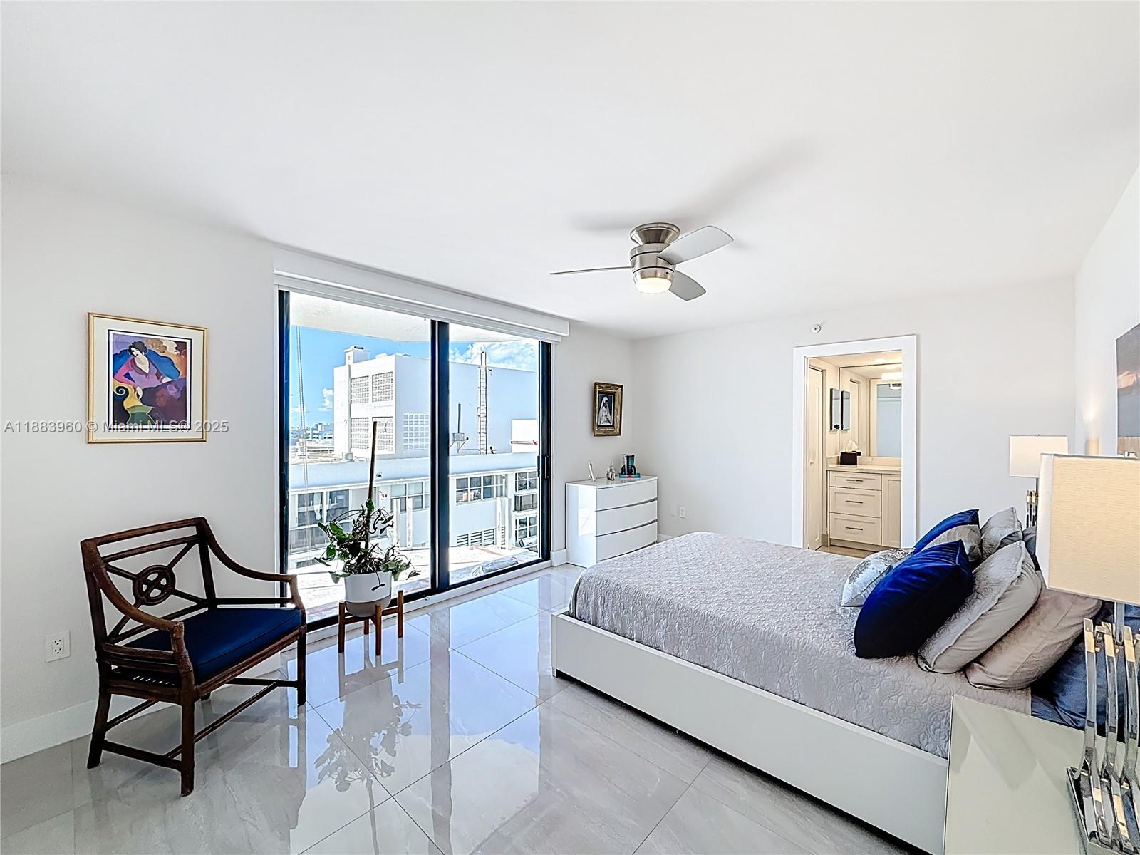 6061 Collins Avenue, Unit 20C Miami Beach, FL 33140 - Photo 12 of 29 a bedroom with a bed and wooden floor