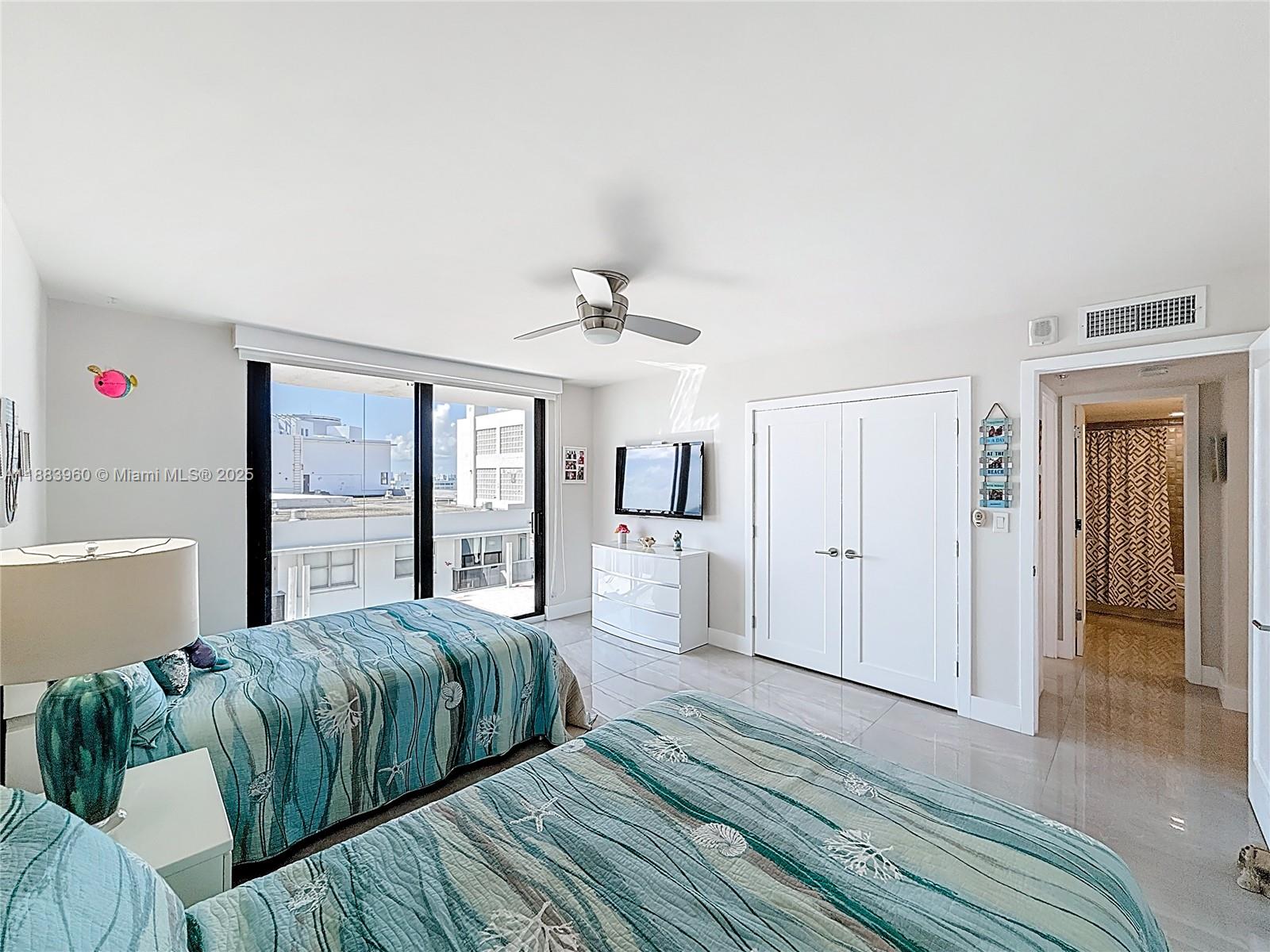 6061 Collins Avenue, Unit 20C Miami Beach, FL 33140 - Photo 19 of 29 a bedroom with a large bed and a window