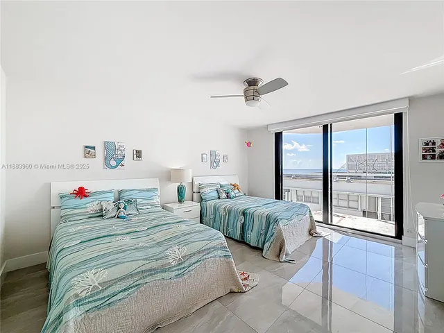 a bedroom with a bed and large window