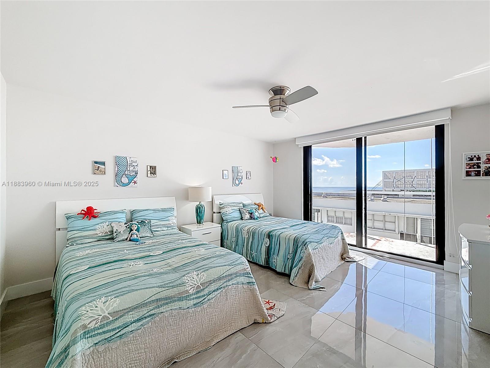 6061 Collins Avenue, Unit 20C Miami Beach, FL 33140 - Photo 20 of 29 a bedroom with a bed and large window