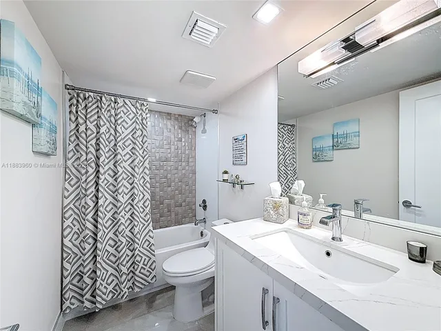 a bathroom with a toilet sink shower and mirror
