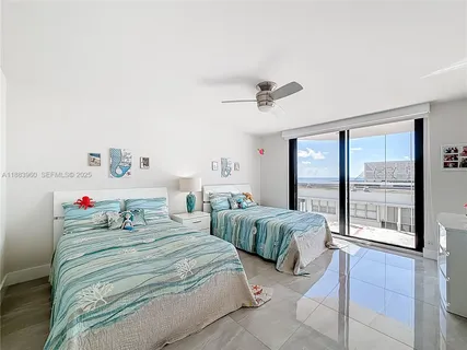 a bedroom with a bed and large window