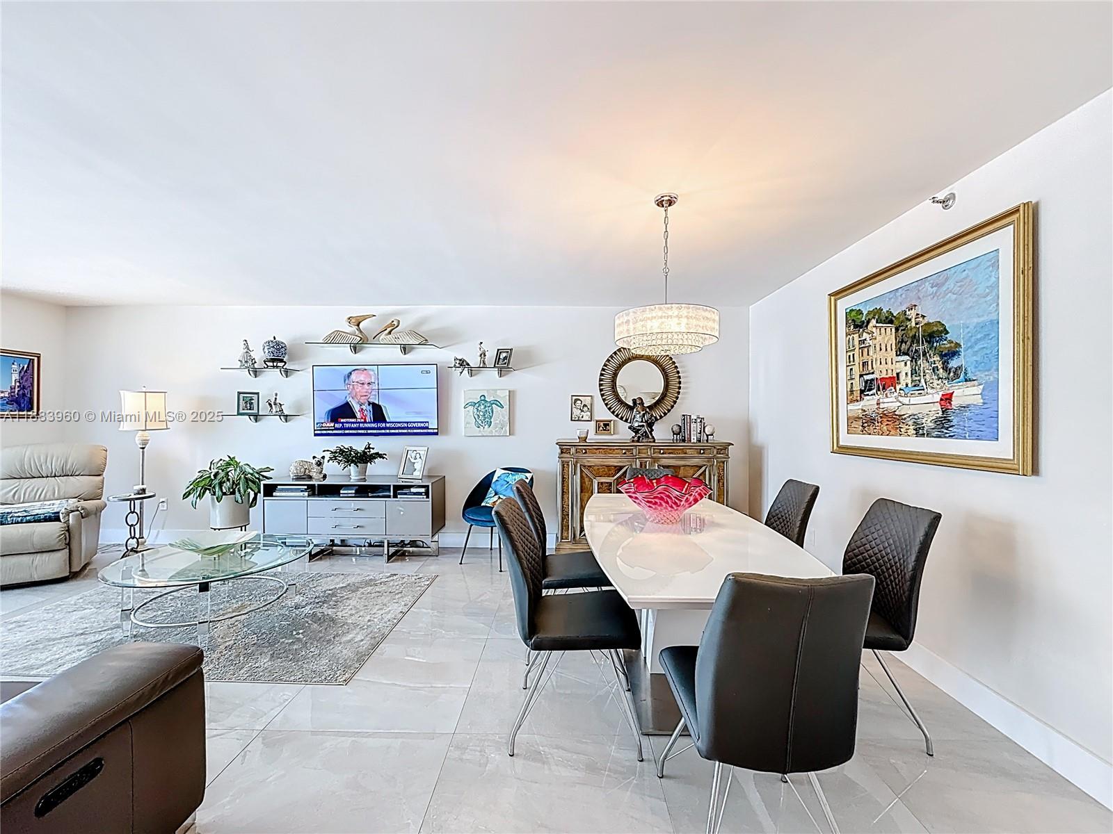 6061 Collins Avenue, Unit 20C Miami Beach, FL 33140 - Photo 5 of 29 a living room with furniture and a table