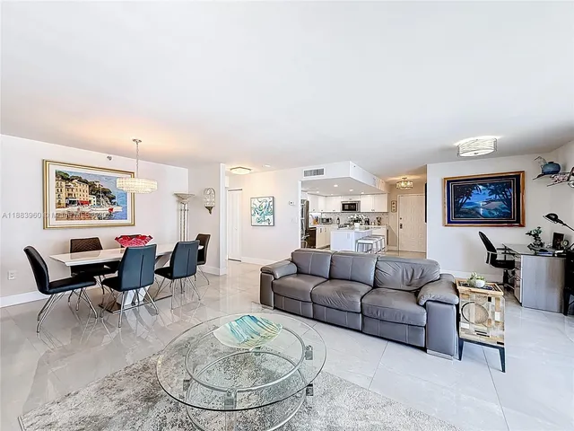a living room with furniture and a dining table with wooden floor