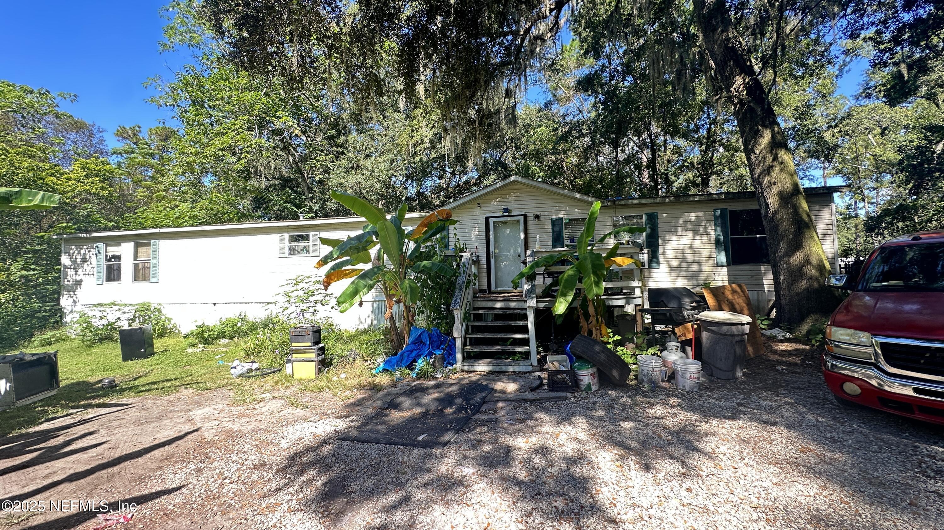 a view of a chair and tables in the backyard of the house
