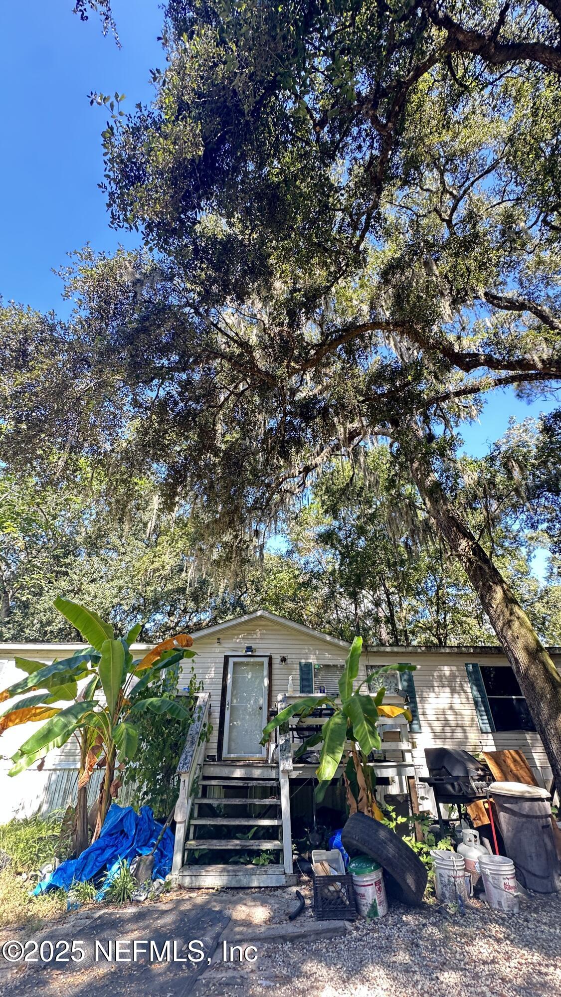 7488 Ricker Road Jacksonville, FL 32244 - Photo 3 of 13 a front view of a house with a yard