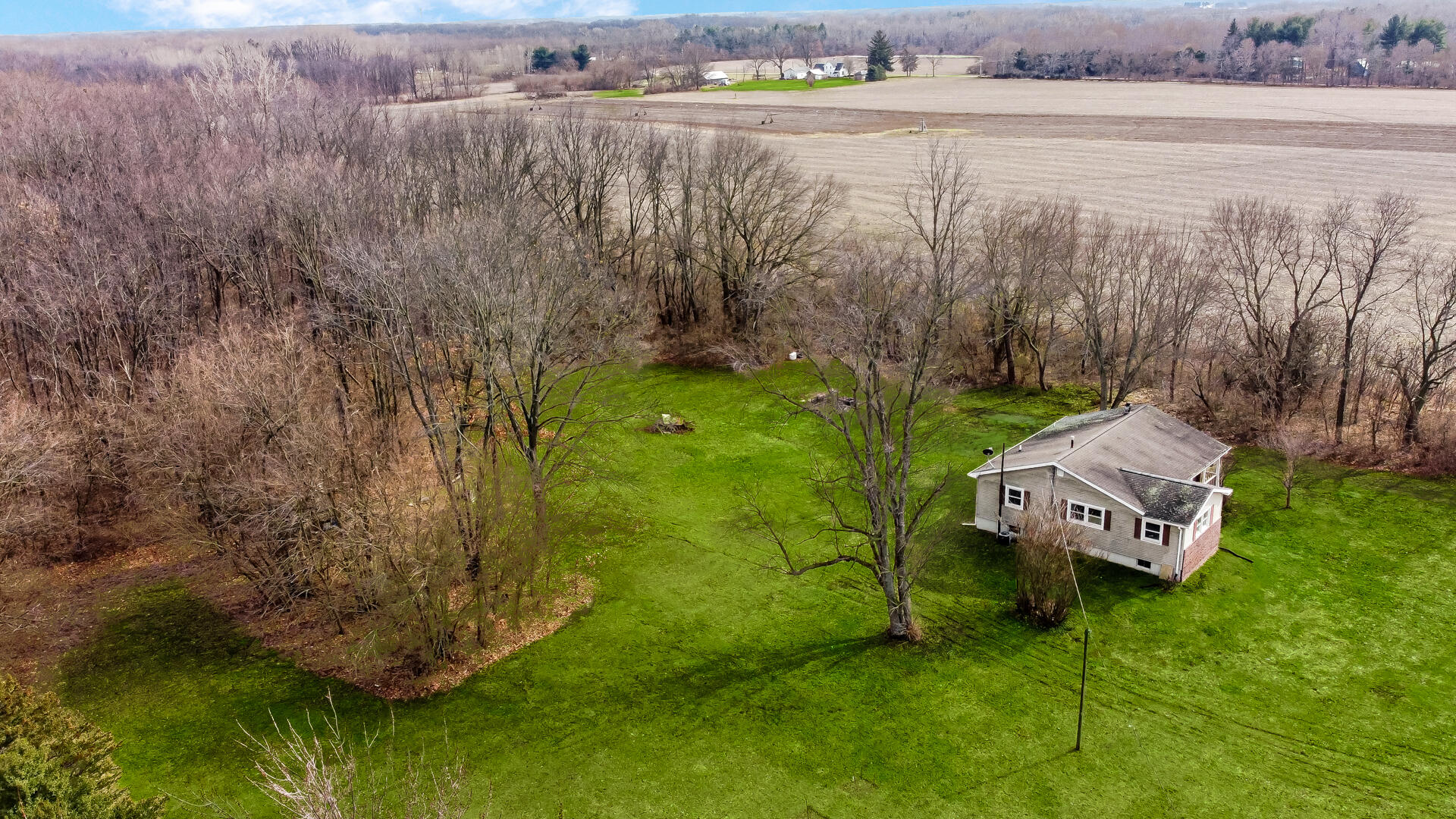65720 Highway 4 Walkerton, IN 46574 - Photo 26 of 35 a view of a lake with lawn chairs and large trees
