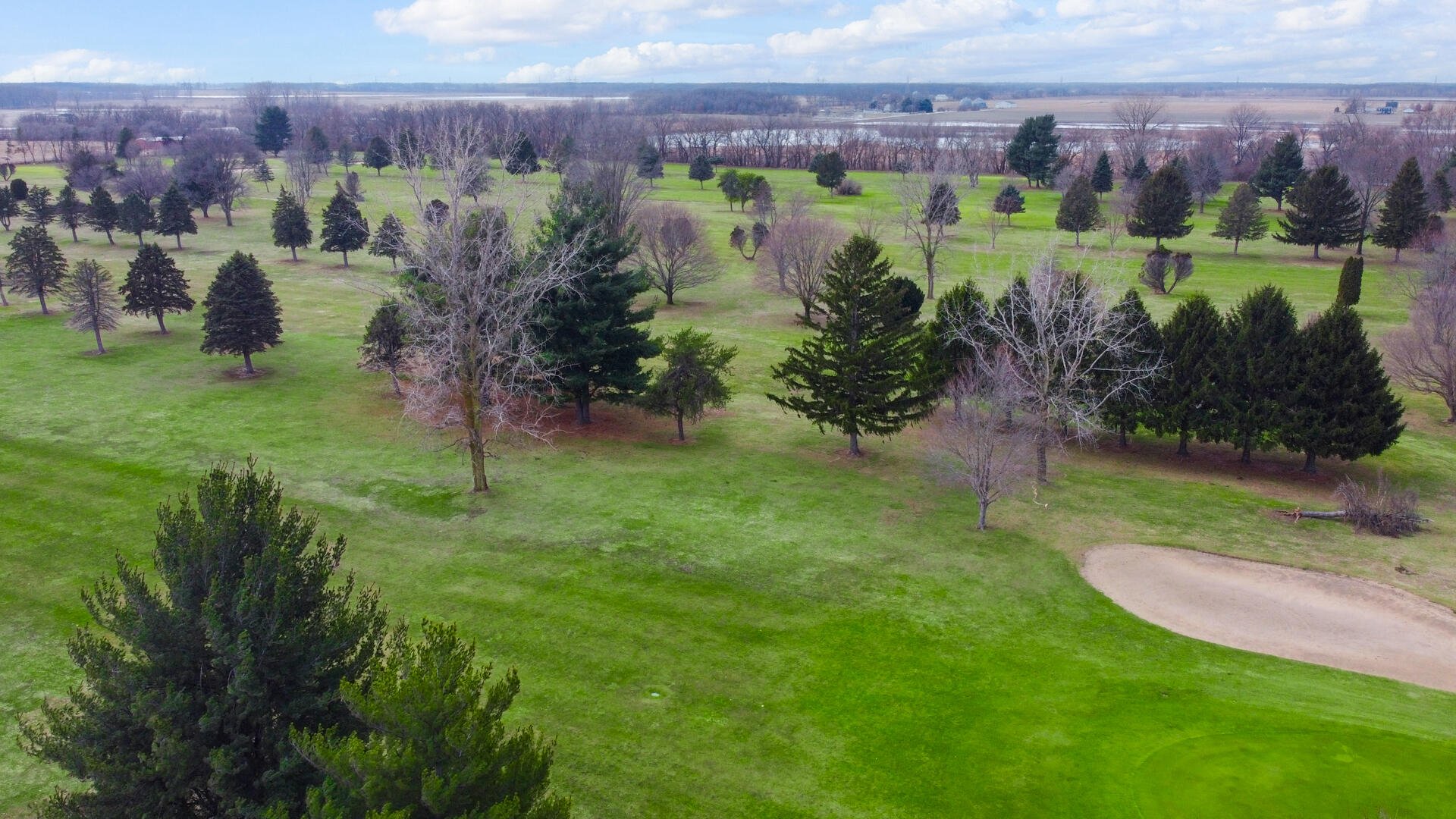 65720 Highway 4 Walkerton, IN 46574 - Photo 3 of 35 an aerial view of a golf course with a lake view