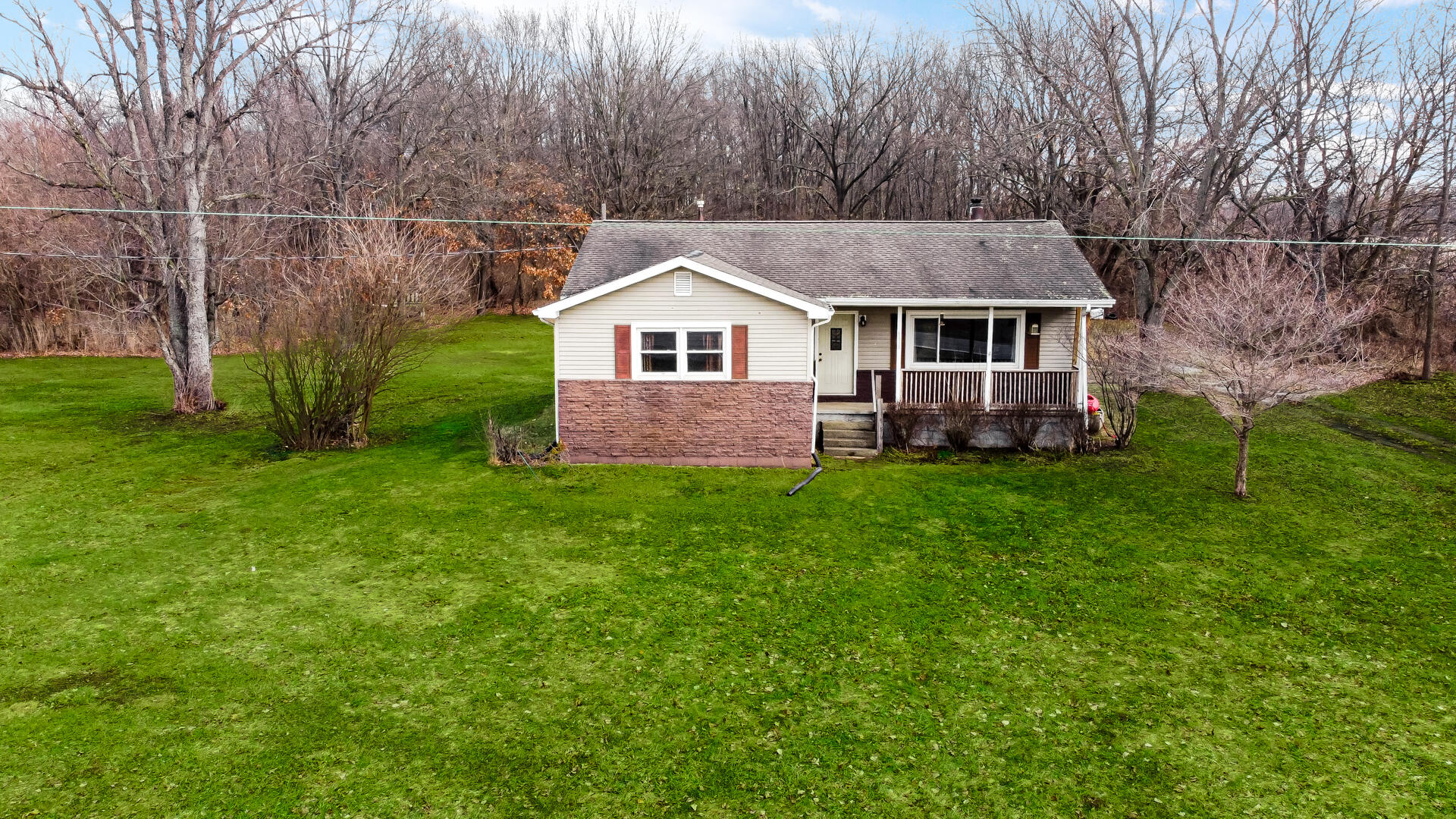 65720 Highway 4 Walkerton, IN 46574 - Photo 5 of 35 a front view of a house with garden