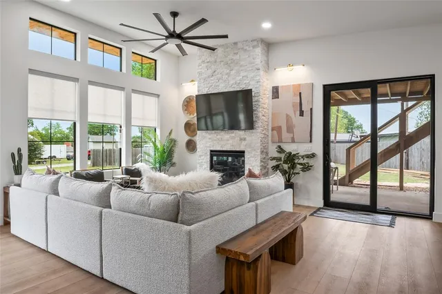 a living room with furniture a flat screen tv and a fireplace
