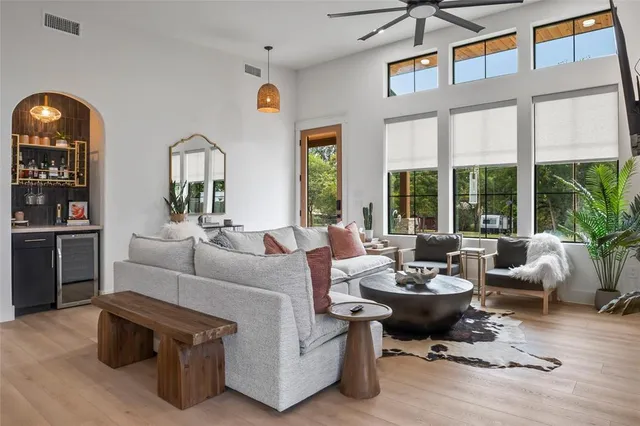 a living room with furniture fireplace and large window