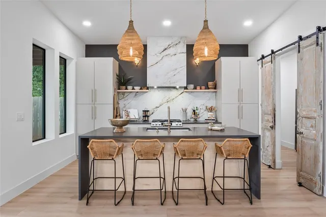 a kitchen with kitchen island granite countertop a table and chairs in it