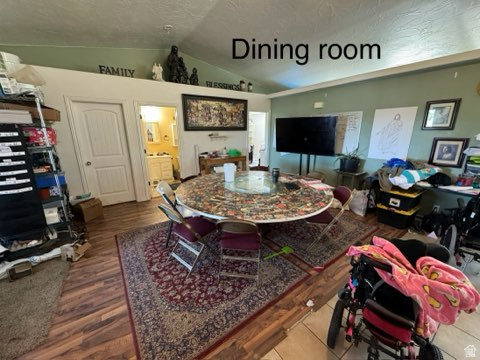 4355 Sagebrush Drive Enoch, UT 84721 - Photo 6 of 13 Living area with lofted ceiling, dark wood-style floors, and a textured ceiling