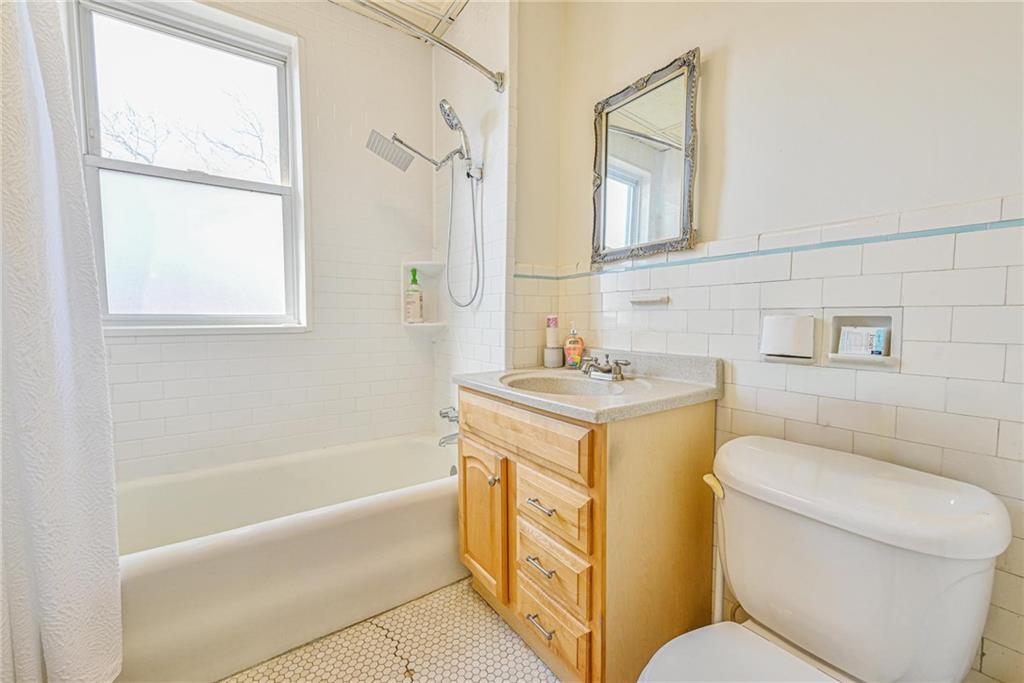 82 Battery Avenue Brooklyn, NY 11228 - Photo 13 of 26 a bathroom with a granite countertop toilet a sink and a bathtub