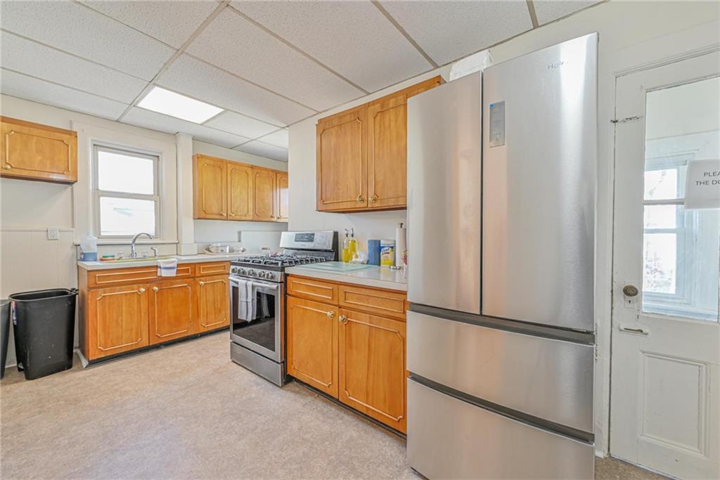 82 Battery Avenue Brooklyn, NY 11228 - Photo 14 of 26 a kitchen with stainless steel appliances granite countertop a refrigerator sink and cabinets