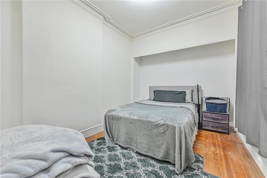 82 Battery Avenue Brooklyn, NY 11228 - Photo 18 of 26 a bedroom with a bed and wooden floor