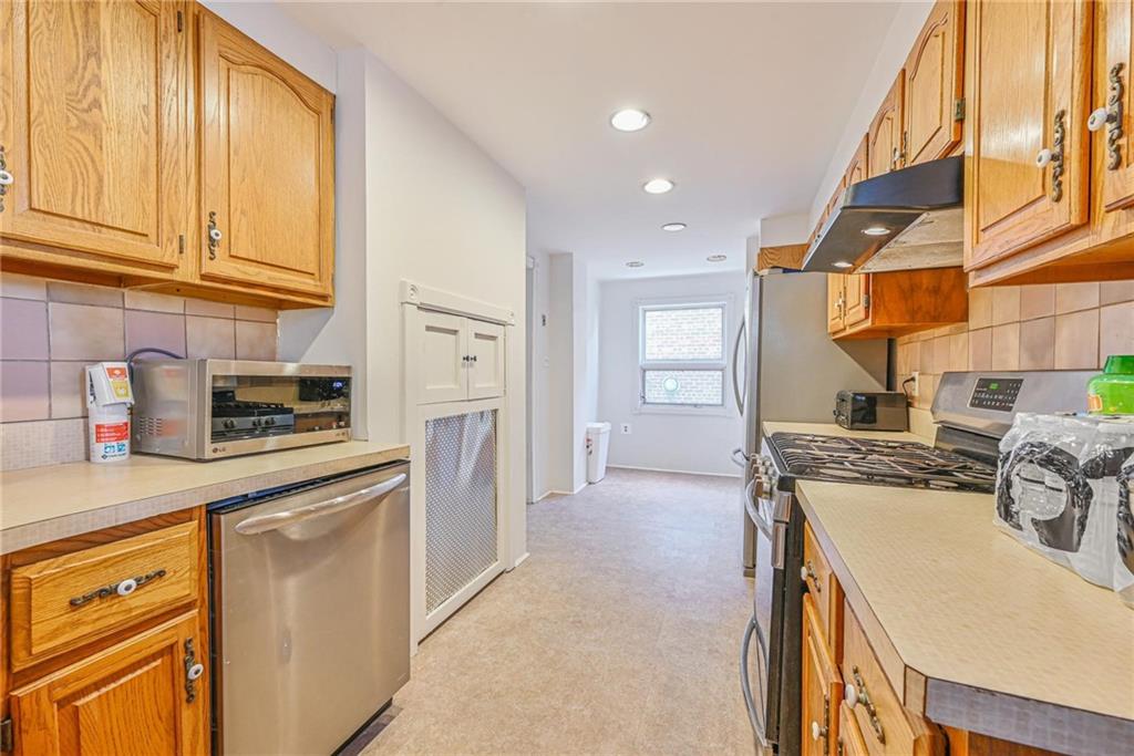 82 Battery Avenue Brooklyn, NY 11228 - Photo 4 of 26 a kitchen with stainless steel appliances granite countertop a stove and a refrigerator