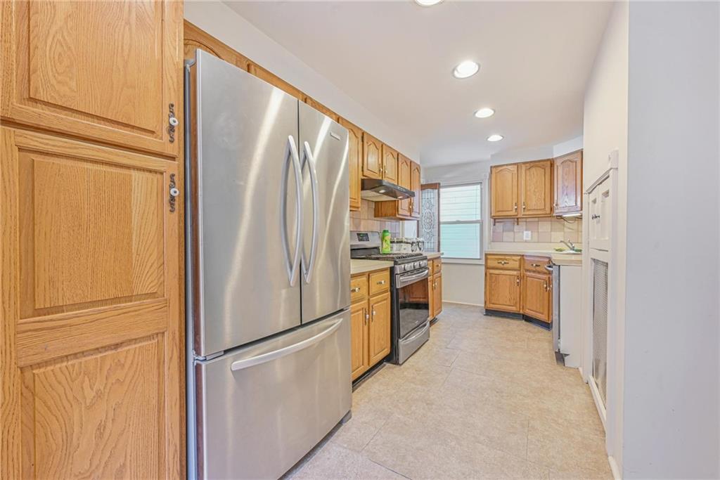 82 Battery Avenue Brooklyn, NY 11228 - Photo 5 of 26 a kitchen with granite countertop stainless steel appliances and refrigerator