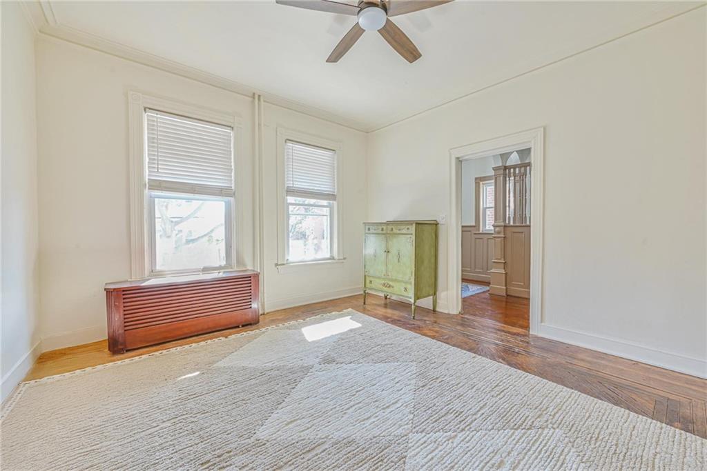 82 Battery Avenue Brooklyn, NY 11228 - Photo 7 of 26 a view of empty room with wooden floor and fan