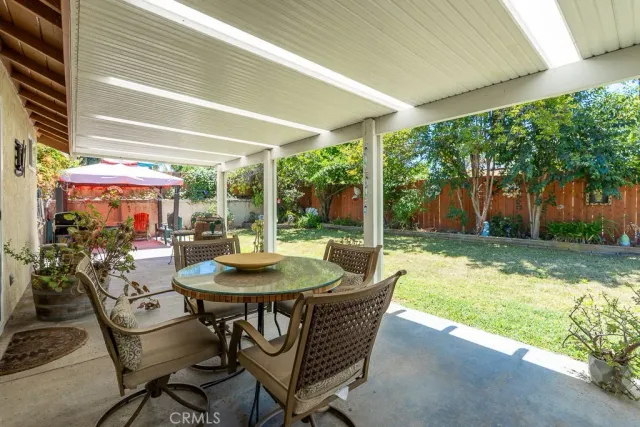 a living room with furniture a fireplace and a chandelier