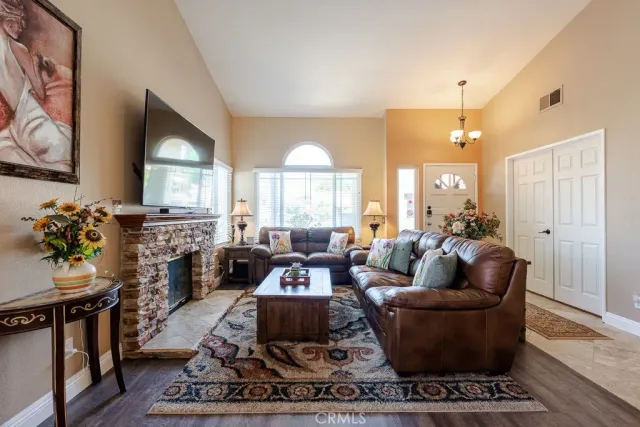 a dining room with furniture a chandelier and wooden floor