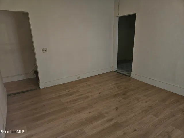 an empty room with wooden floor