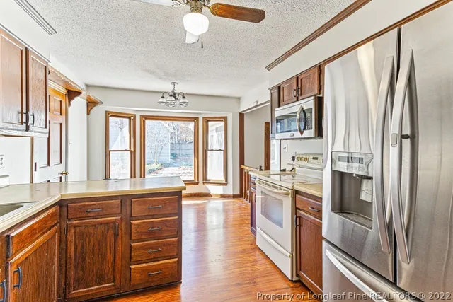 a kitchen with stainless steel appliances a stove cabinets and a refrigerator