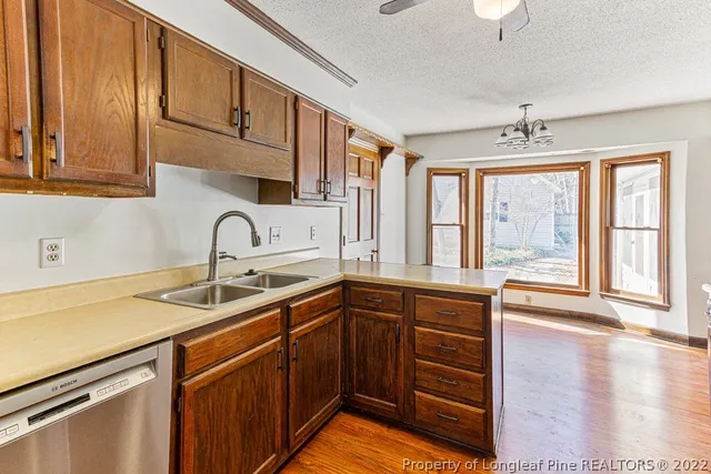 a kitchen with stainless steel appliances granite countertop a sink and cabinets